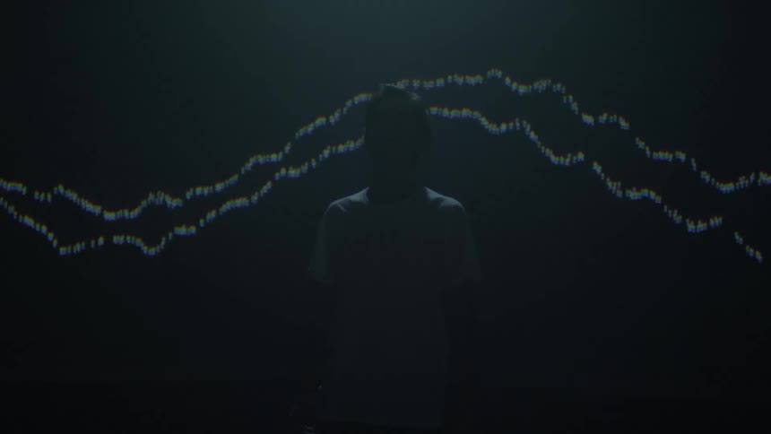 Man stands in front of flashing lights